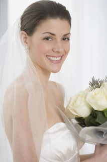 Portrait of bride holding bouquet.