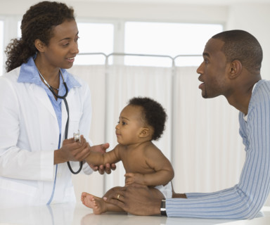 Female doctor examining baby.