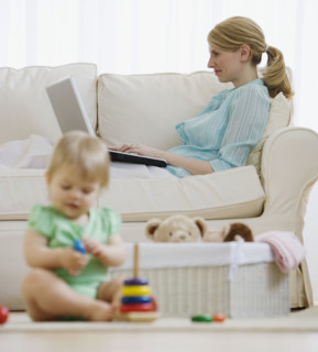 Mother and baby relaxing in living room.