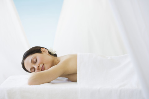 Woman laying on spa table.