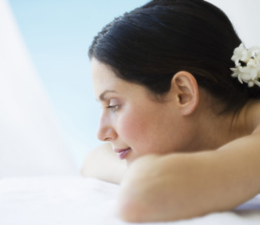Woman laying on spa table.