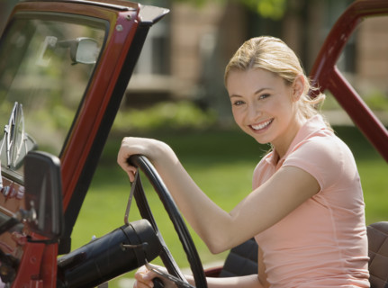 Woman sitting in jeep.