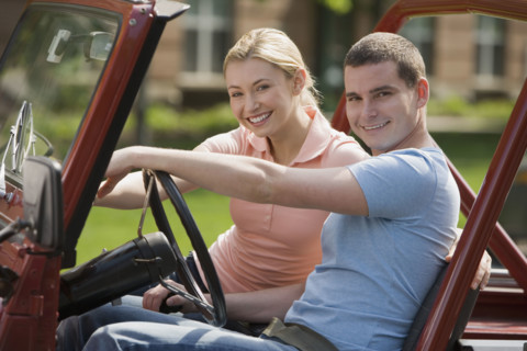 Couple sitting in jeep.