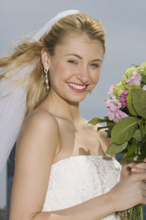 Bride holding bouquet of flowers.