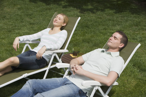 Couple sitting in lounge chairs.