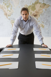 Businessman at head of conference table.