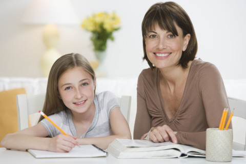 Mother helping daughter with homework.