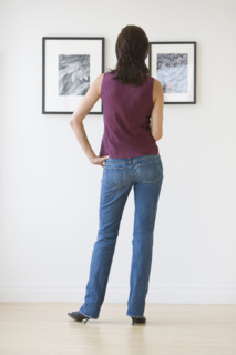 Woman looking at artwork in gallery.