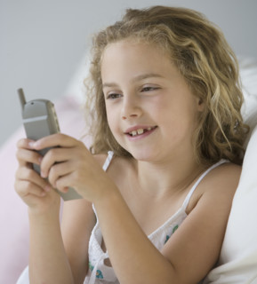 Girl dialing cell phone.