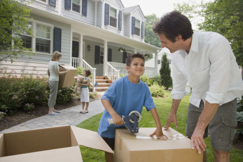 Family packing moving boxes.