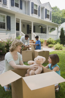 Family unpacking moving boxes.