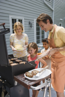 Family barbequing on deck.