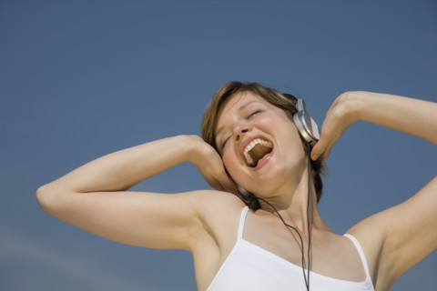 Woman listening to headphones.