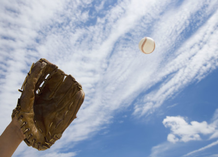 Hand in baseball glove catching ball.