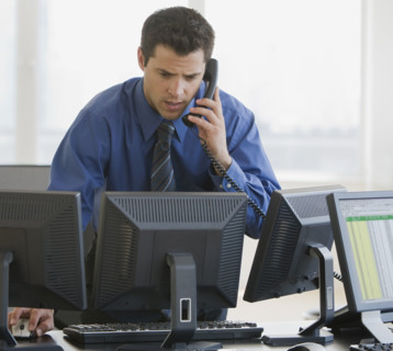 Businessman talking on telephone.