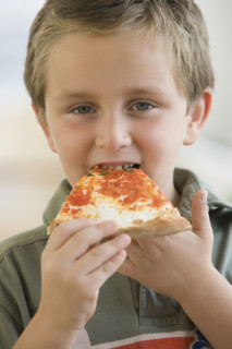 Boy eating pizza.