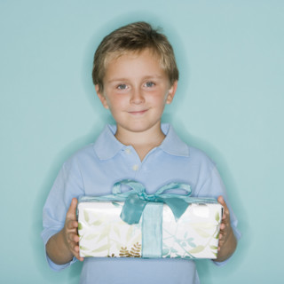 Boy holding gift.