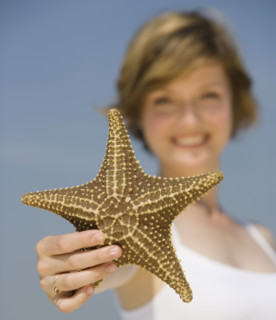Woman holding starfish.
