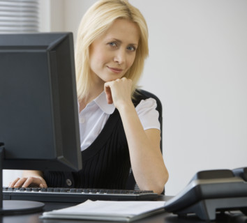 Businesswoman sitting at desk.