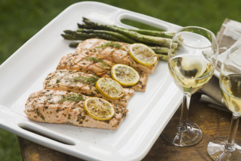 Grilled fish and asparagus on platter.