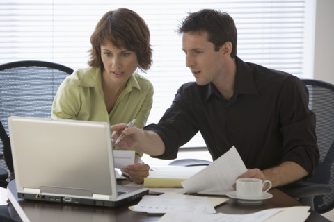Couple paying bills online.