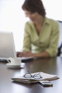 Woman typing on laptop.