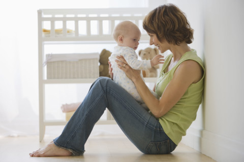 Mother playing with baby.