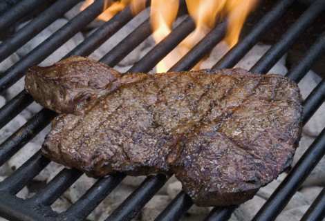 Steak cooking on grill.