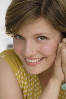 Close up of woman smiling.