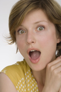 Close up of woman looking surprised.