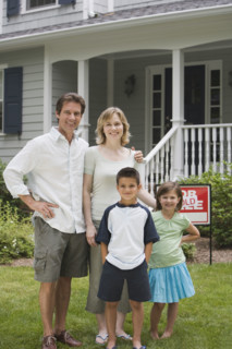 Family in front of new house.