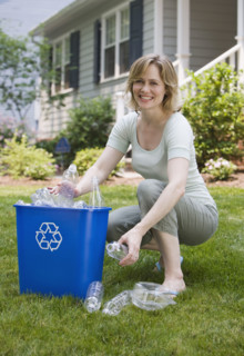Woman filling recycling bin.