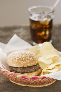 Hamburger and chips in basket.