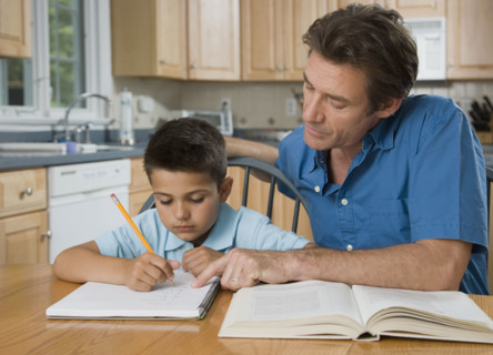 Father helping son with homework.