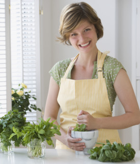 Woman grinding fresh herbs.