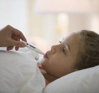 Girl having temperature taken.