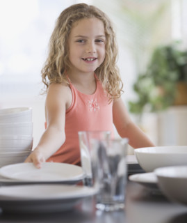 Girl setting table.