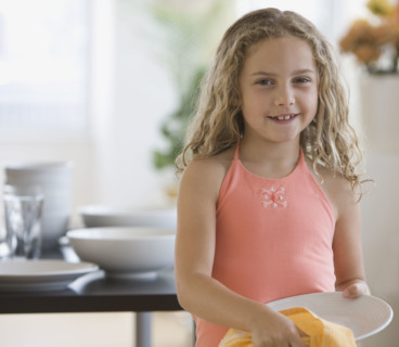 Girl drying off dish.