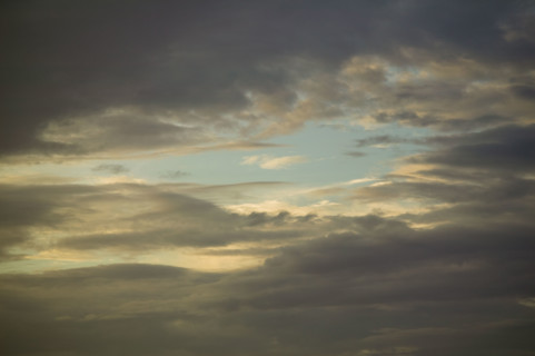Sun shining through cloudy sky.