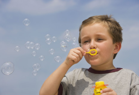 Boy blowing bubbles.