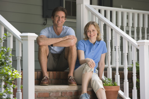 Couple sitting on porch steps.
