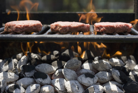 Hamburgers cooking on grill.