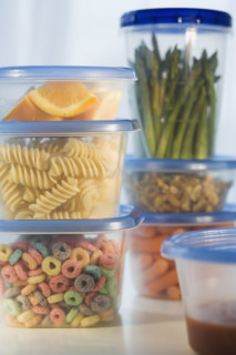 Stacked plastic containers of food.