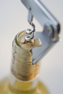 Close up of corkscrew in wine bottle.
