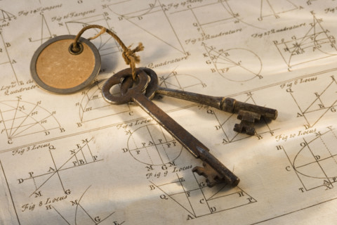 Old fashioned keys on sheet of geometry.