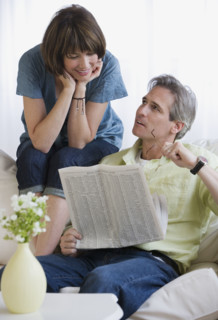 Couple looking at newspaper.