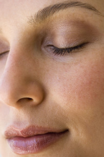 Woman’s face with eyes closed.