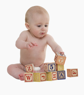 Studio shot of baby playing with blocks.