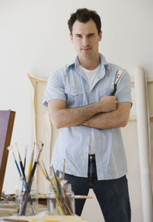 Male artist in painting studio.