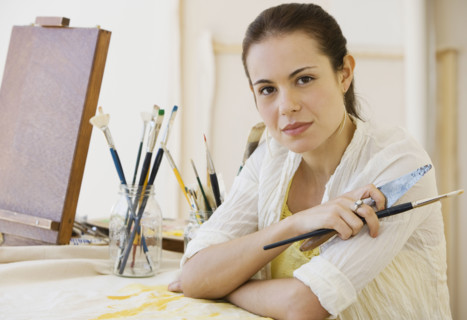 Female artist in painting studio.